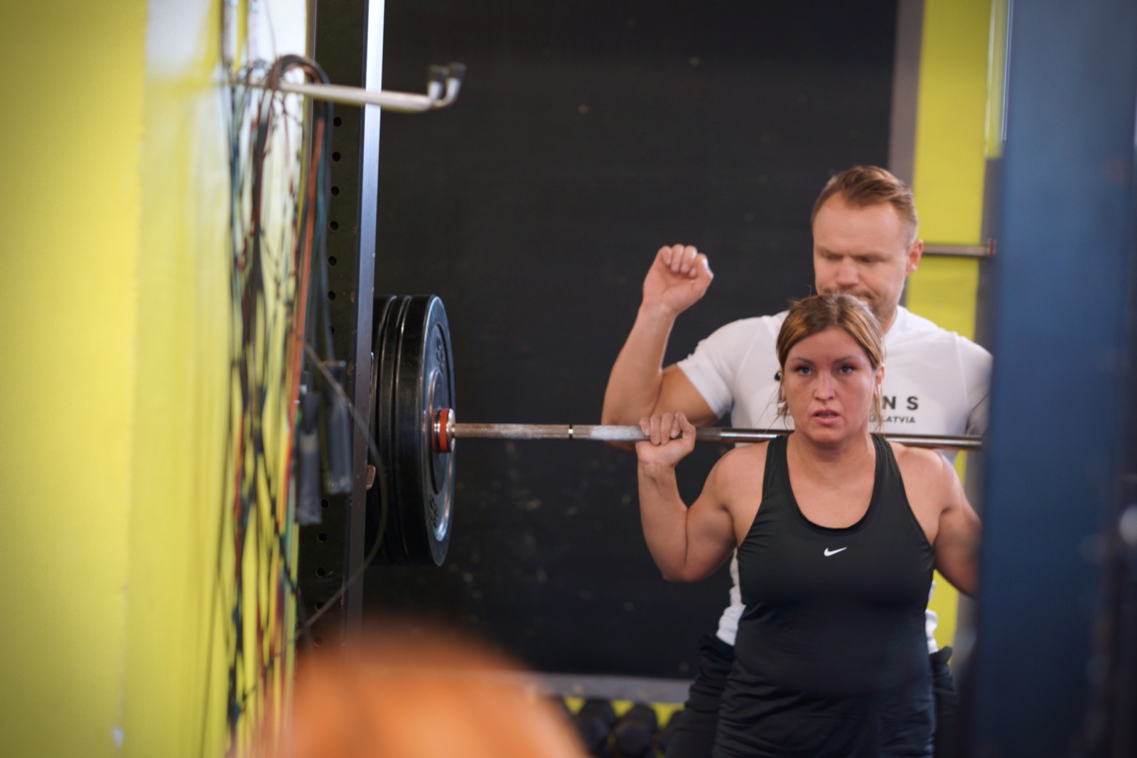 Kārlis coaching a squat at CrossFit Urban Tribe